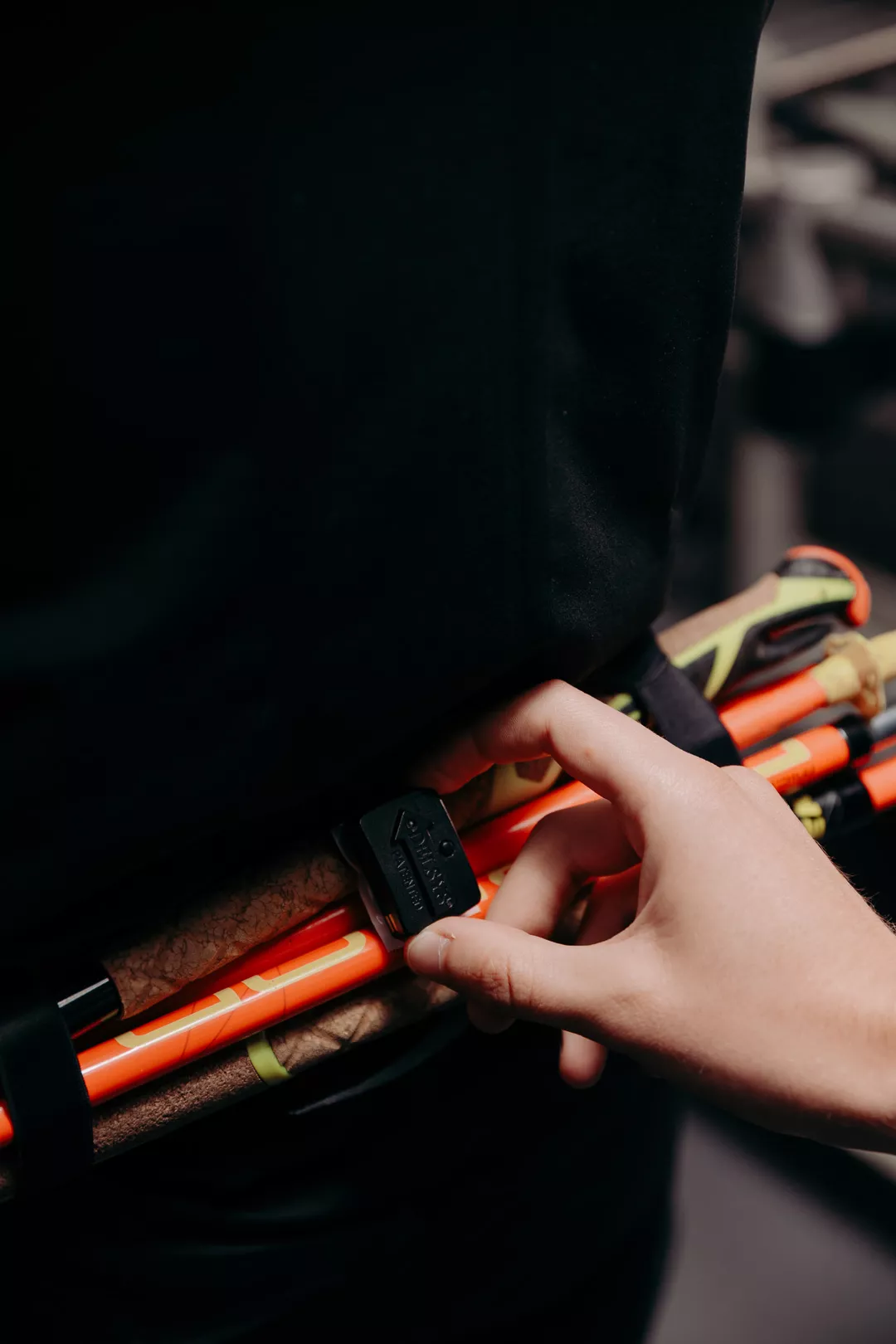 Hand adjusting the strap of a Compressport running pack